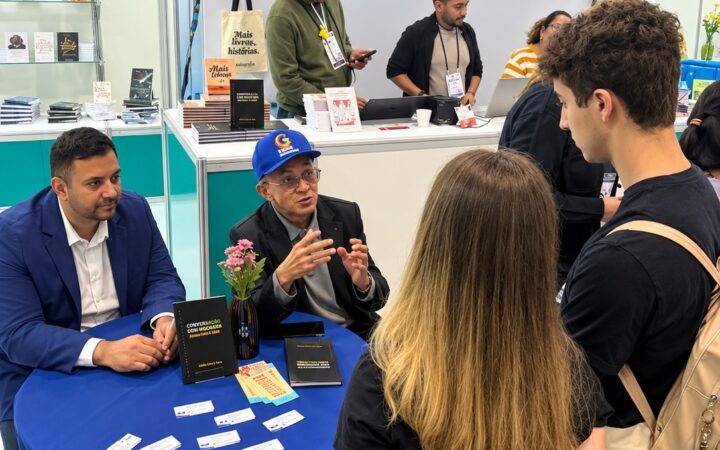Professor Bibiano Costa de boné azul durante autógrafos na Bienal.
